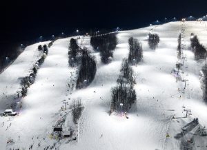 night skiiers take advantage of uniform lighting on the slopes